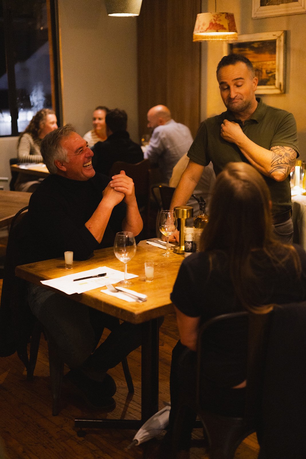 The owner of Woodlands Eatery, chatting with two customers.